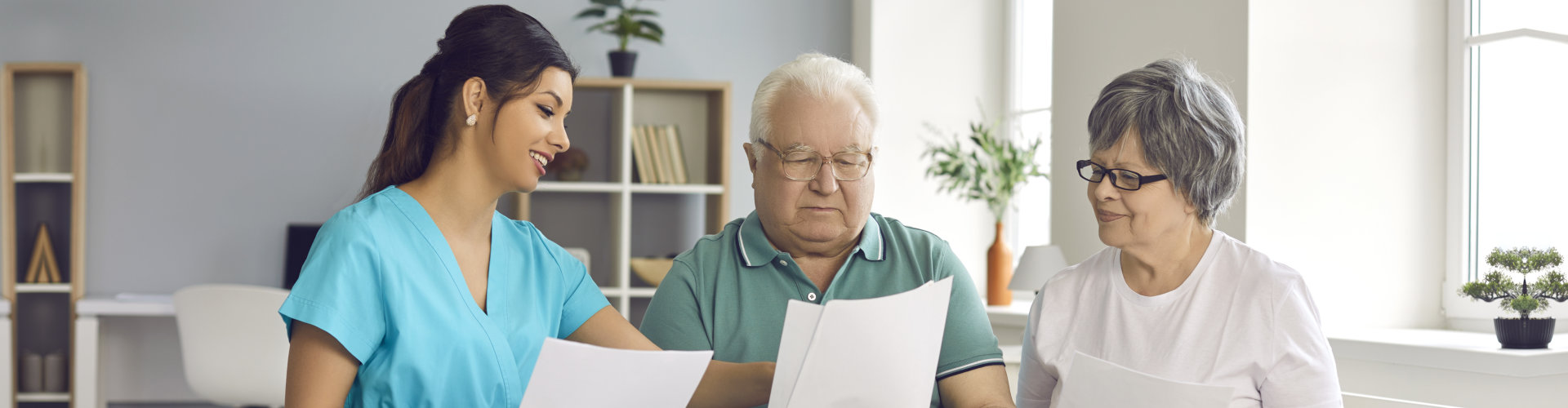 nurse and a senior patient reading something